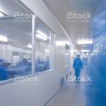 Chinese hospital laboratory working with unrecognizable technician in blue